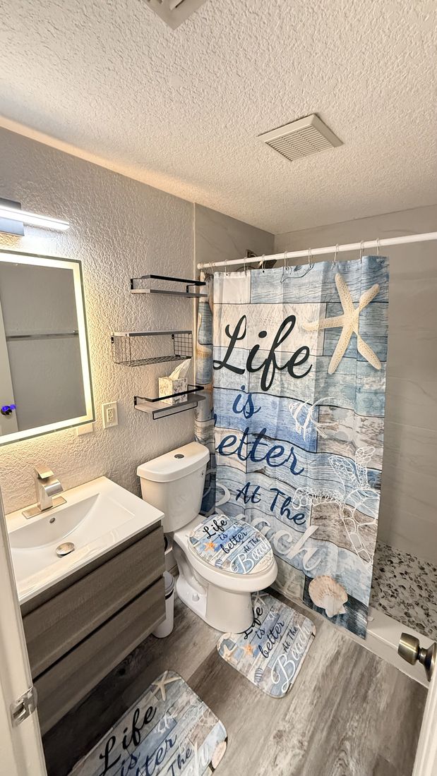 Coastal-themed bathroom remodel with new vanity and flooring