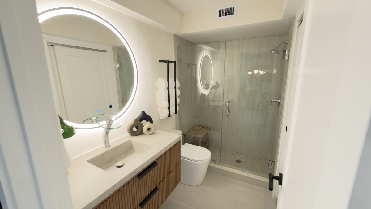 Modern bathroom remodel with frameless glass shower and floating vanity