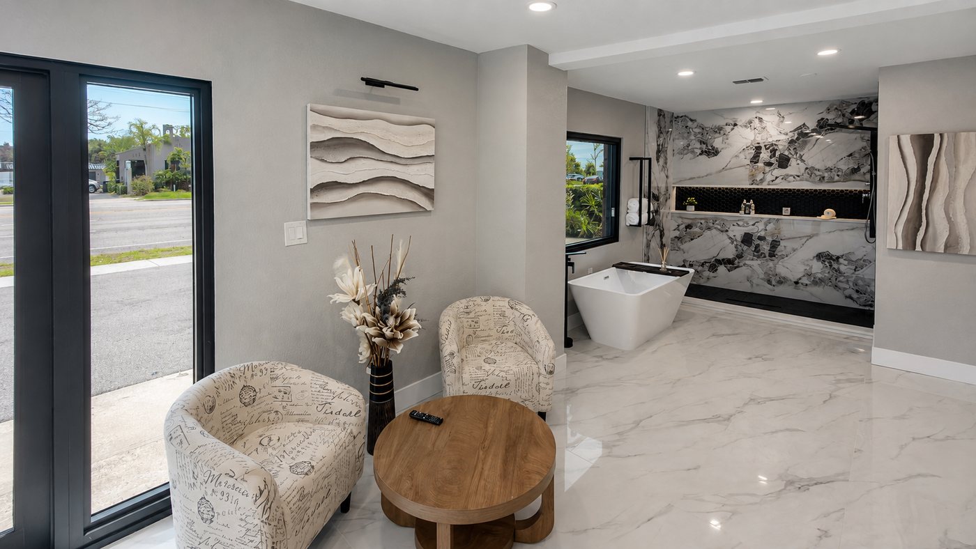 Interior of the SQ.1 Design Build showroom in Sarasota, with a display bath and finish samples