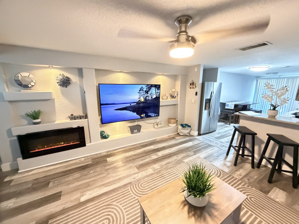 Living room renovation with built-in electric fireplace and media wall