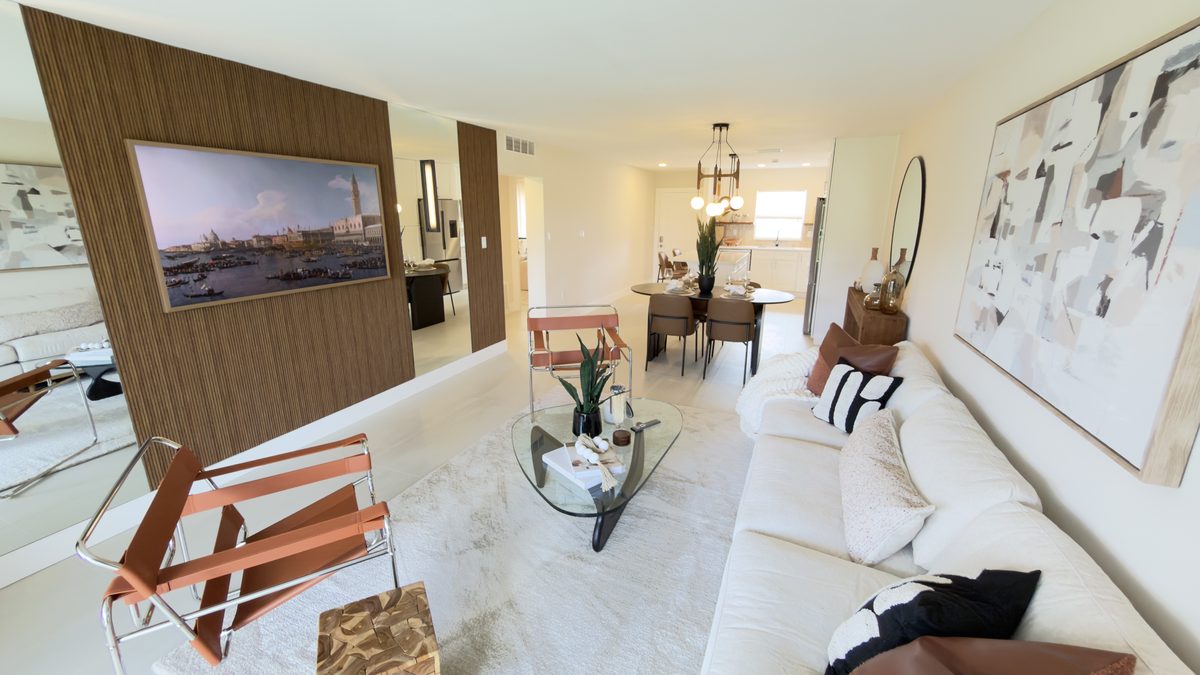 Renovated living and dining space with wood feature wall