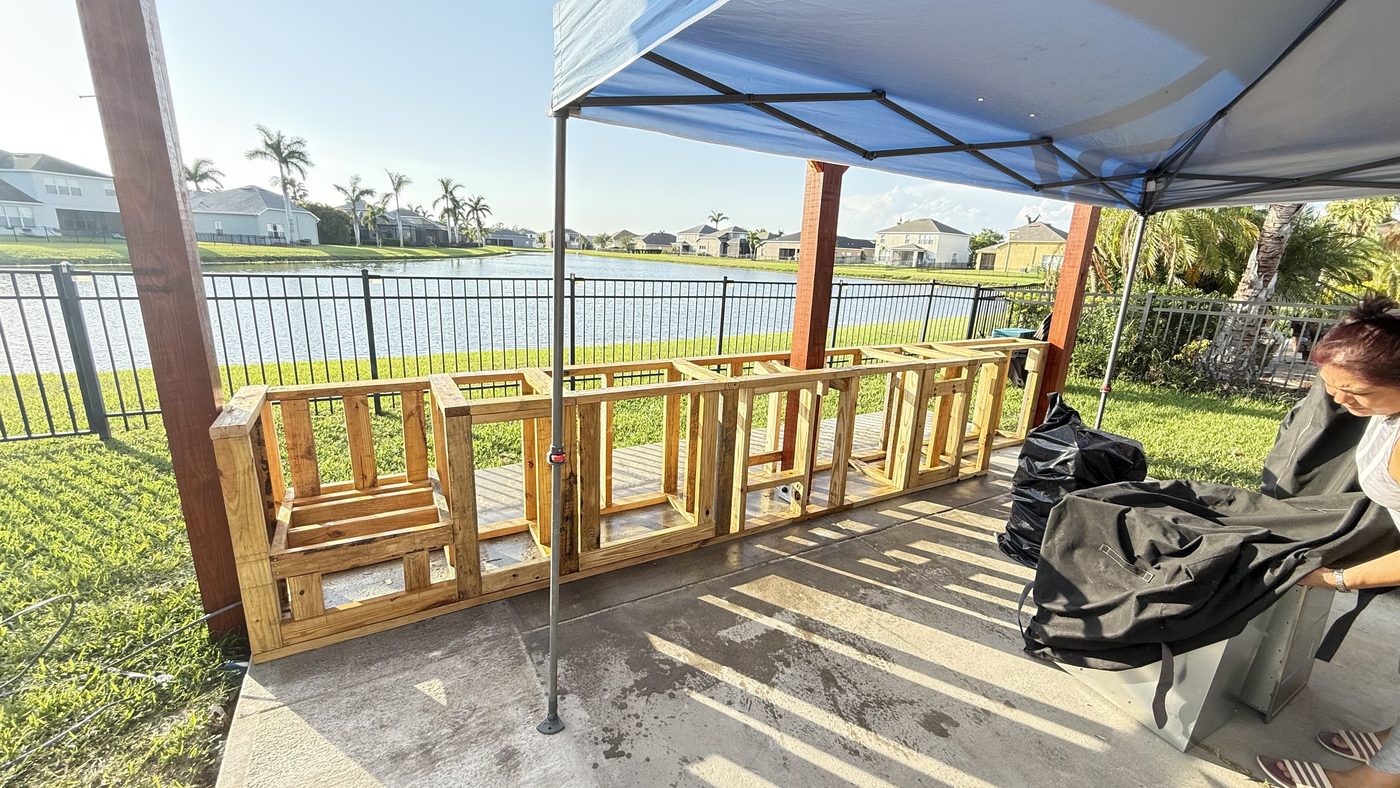 Outdoor pergola under construction, showing framing and posts